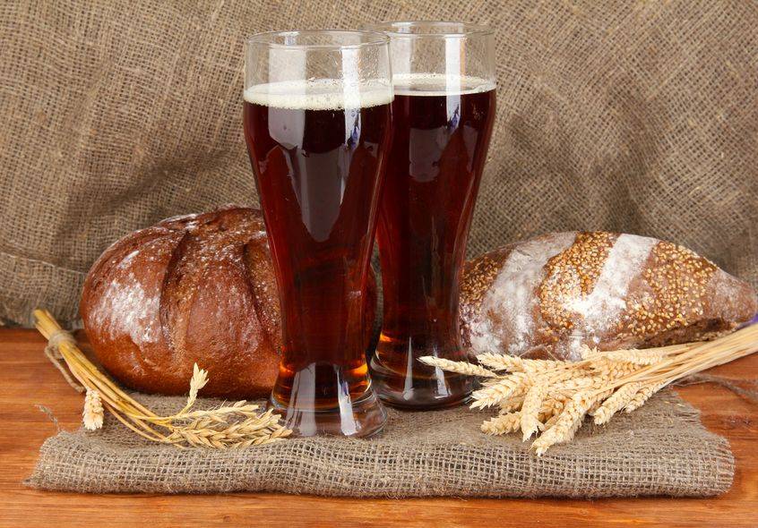 two glasses of kvass with bread on canvas background close-up